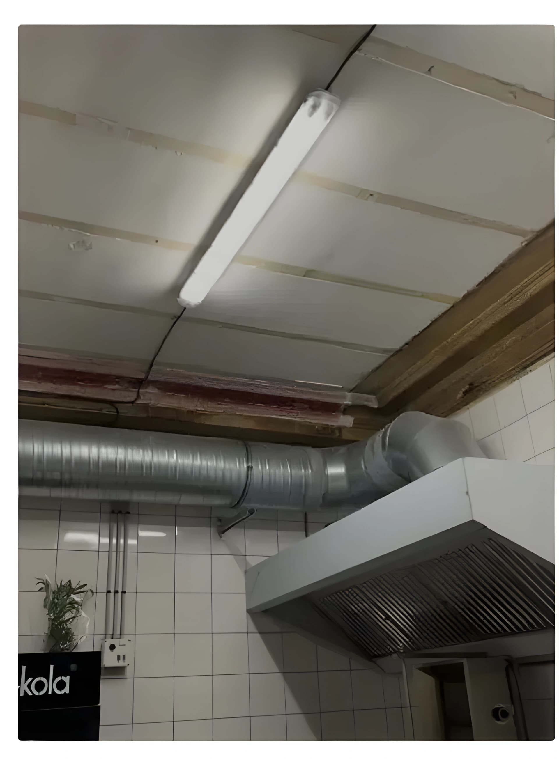 Commercial kitchen ventilation hood and ductwork in a restaurant facility