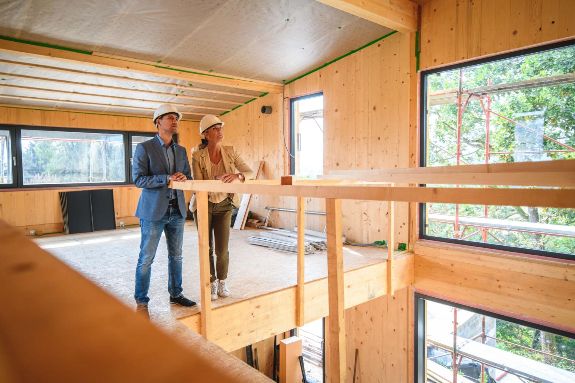 Construction professionals reviewing a building project in hard hats