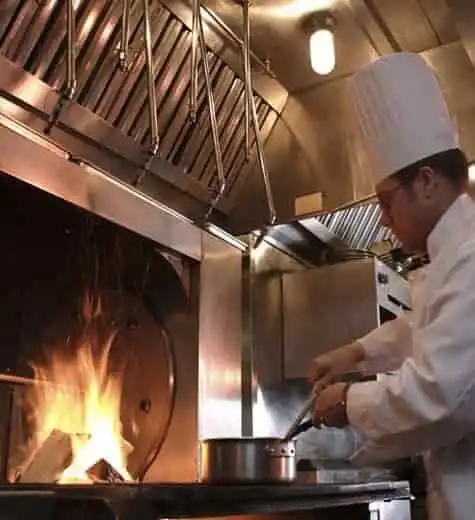 Professional chef cooking on a commercial kitchen stove